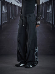 NOMANIAI Loose-fit casual trousers with a washed, distressed finish and totem print.