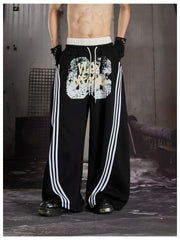 NOMANIAI Y2K Graffiti-Print Casual Pants with Double-Layer Waistband and Three-Stripe Detail.