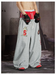 NOMANIAI Street-style loose-fit casual trousers with double-waistband embroidery.