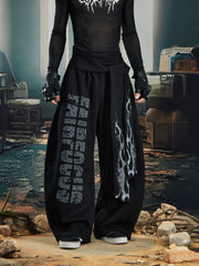 NOMANIAI Loose-fitting trousers with a totem print and Y2K-style lace-up detailing.