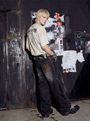 NOMANIAI Distressed Short-Sleeve T-Shirt with Rips and Vintage-Style Print.