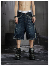 NOMANIAI Oversized, cropped, studded denim jeans with a punk-style distressed wash.