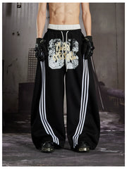 NOMANIAI Y2K Graffiti-Print Casual Pants with Double-Layer Waistband and Three-Stripe Detail.