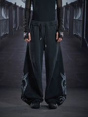 NOMANIAI Loose-fit casual trousers with a washed, distressed finish and totem print.