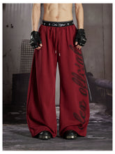 NOMANIAI Loose-fit casual trousers with double-waistband design and totem print.