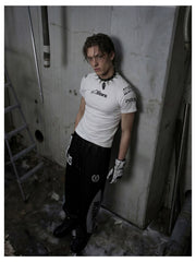 NOMANIAI Street-style casual pants featuring a draped fit, paneling, and a print design.