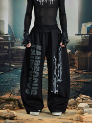 NOMANIAI Loose-fitting trousers with a totem print and Y2K-style lace-up detailing.