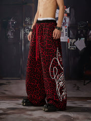 NOMANIAI Y2K-style loose-fit casual pants with leopard print and totem motifs.