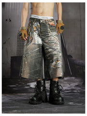 NOMANIAI Loose-fit cropped trousers featuring a 3D-printed plaid pattern and chain detailing.