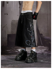 NOMANIAI Cropped jeans with rhinestone and embroidery totem design.