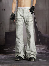 NOMANIAI Edgy, dark-style street-look flared jeans with paint-splatter and stud details.