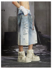 NOMANIAI Y2K-style loose-fit cropped pants featuring a triple-waistband design and chain charm detail.