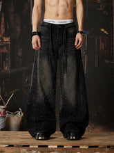 NOMANIAI Loose-fit, acid-washed, distressed denim jeans featuring rhinestone-studded streamers.