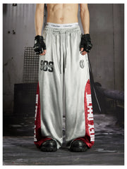 NOMANIAI Street-style casual pants featuring a draped fit, paneling, and a print design.