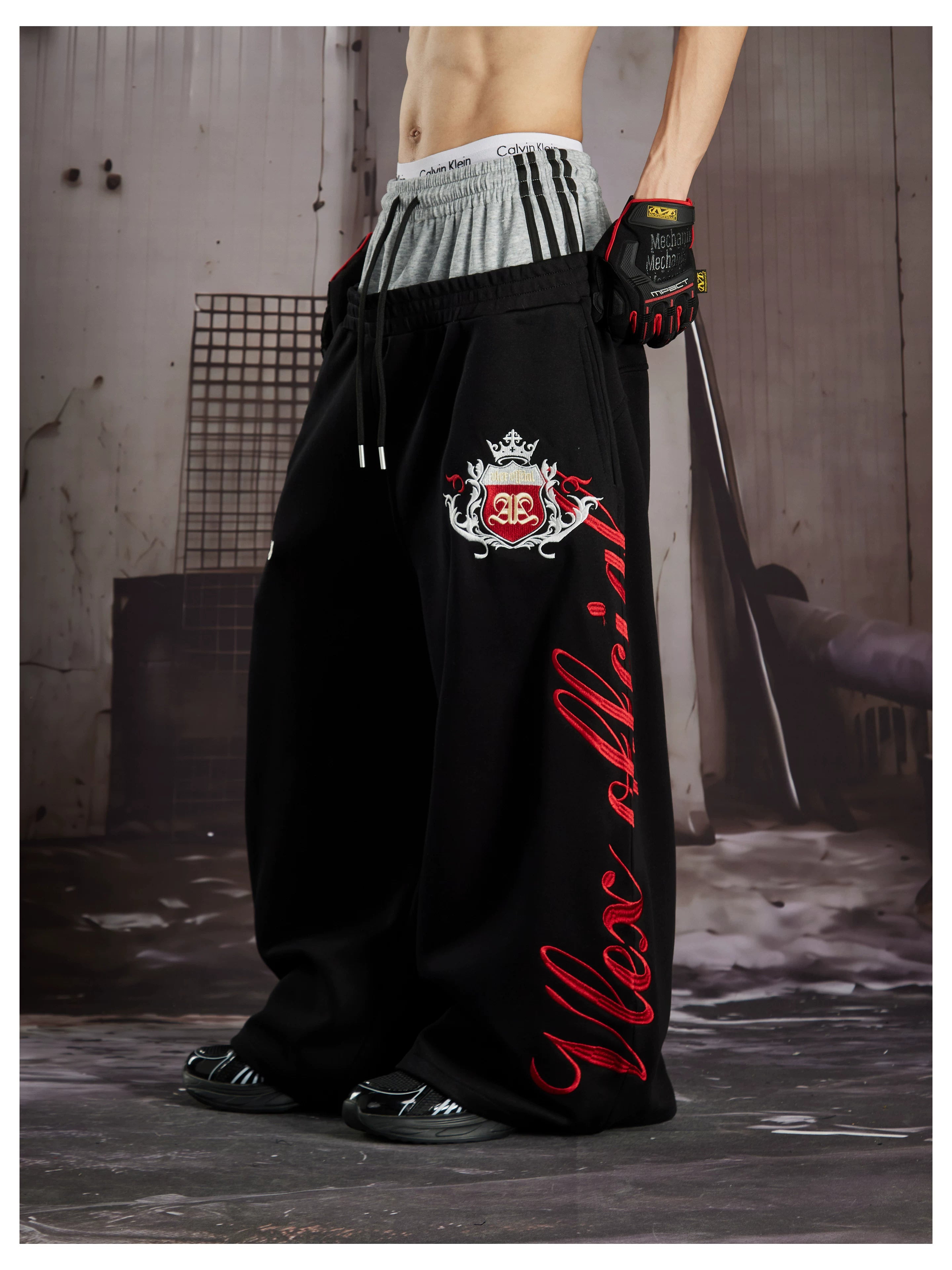 NOMANIAI  Street-style loose-fit casual trousers with double-waistband embroidery.