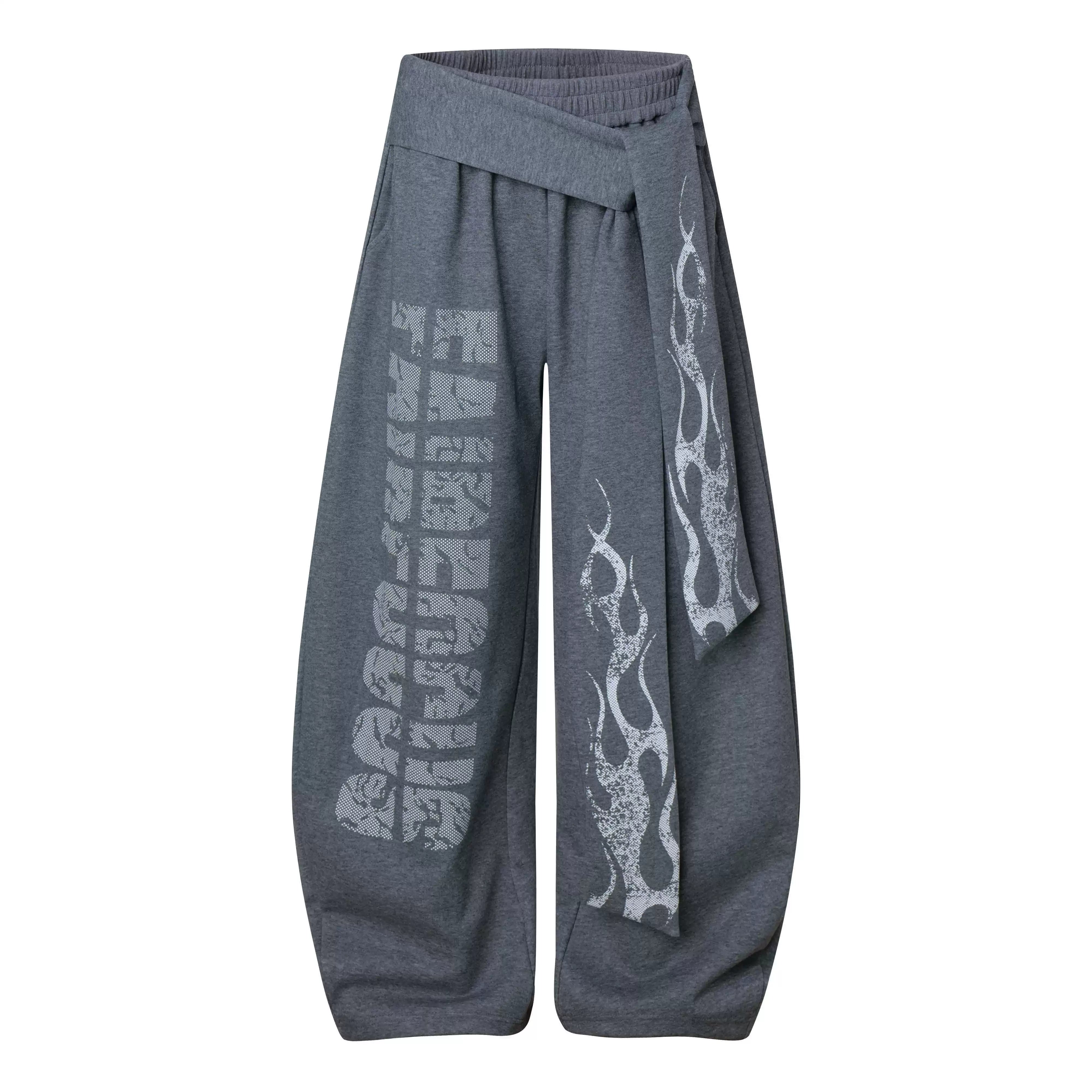 NOMANIAI Loose-fitting trousers with a totem print and Y2K-style lace-up detailing.