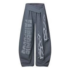 NOMANIAI Loose-fitting trousers with a totem print and Y2K-style lace-up detailing.