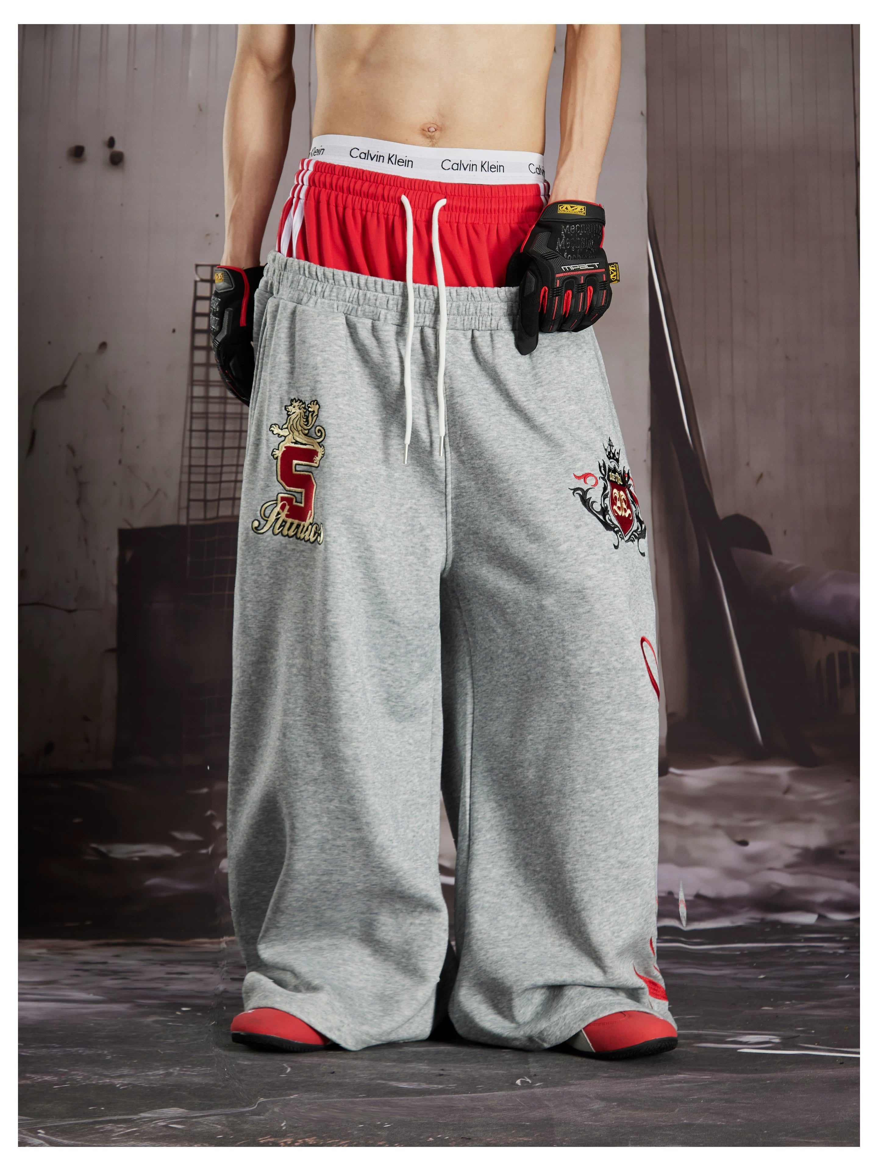 NOMANIAI  Street-style loose-fit casual trousers with double-waistband embroidery.