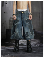 NOMANIAI Distressed, raw-edge, deconstructed loose-fit denim shorts Cropped trousers.