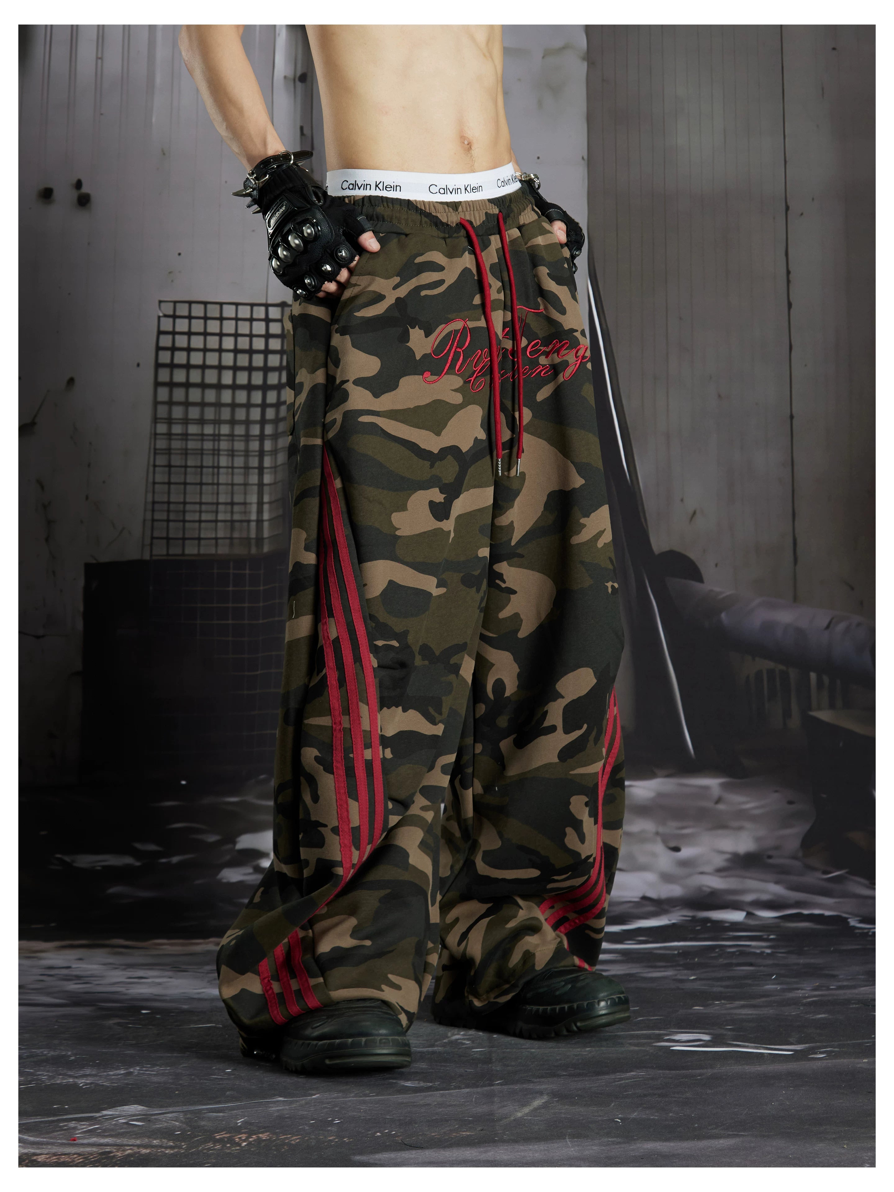 NOMANIAI Street-style embroidered camouflage casual pants with three-stripe detailing.
