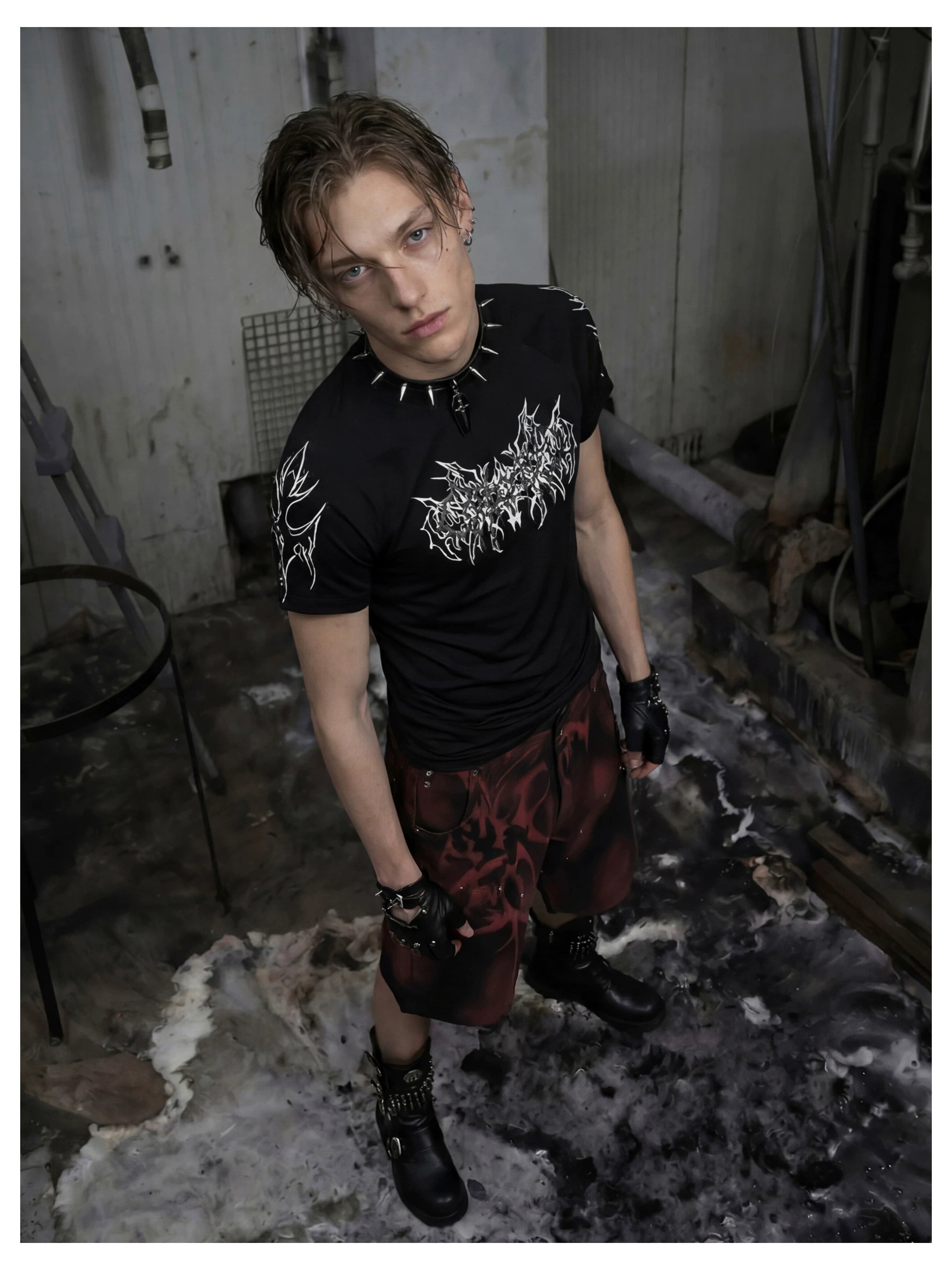 NOMANIAI Y2K loose-fit denim shorts with hand-drawn motifs and studs.