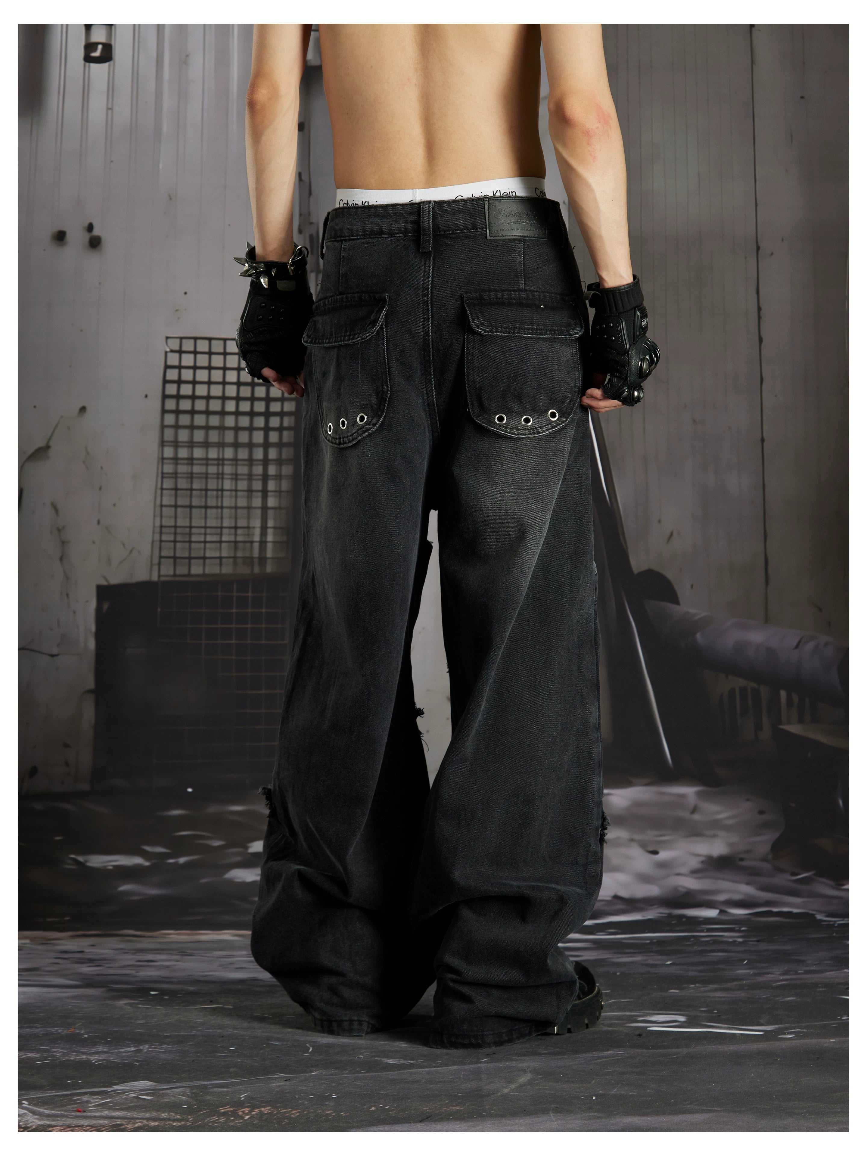 NOMANIAI  Panel-construction straight-leg jeans with rivets and a distressed wash.