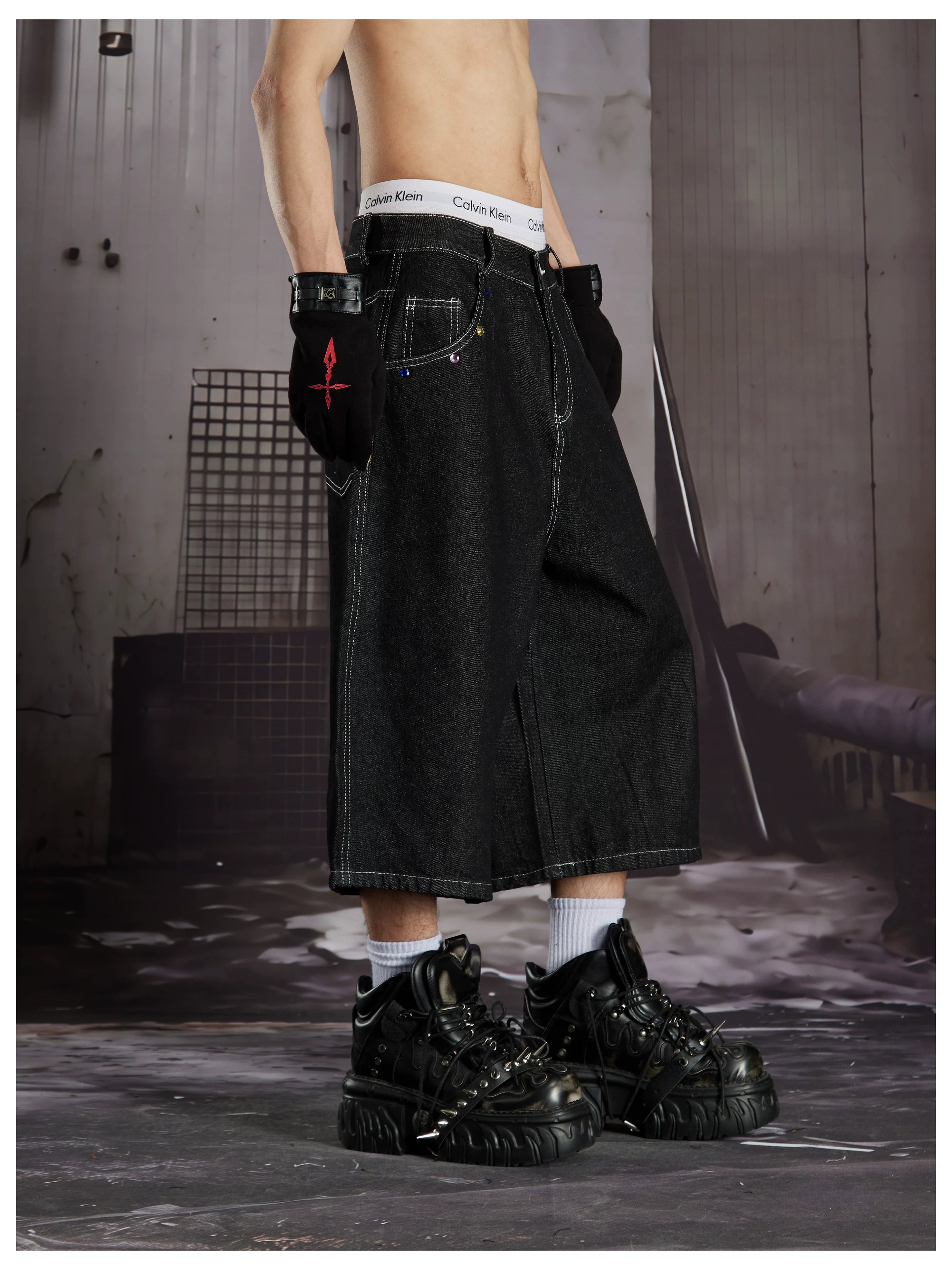NOMANIAI Cropped jeans with rhinestone and embroidery totem design.