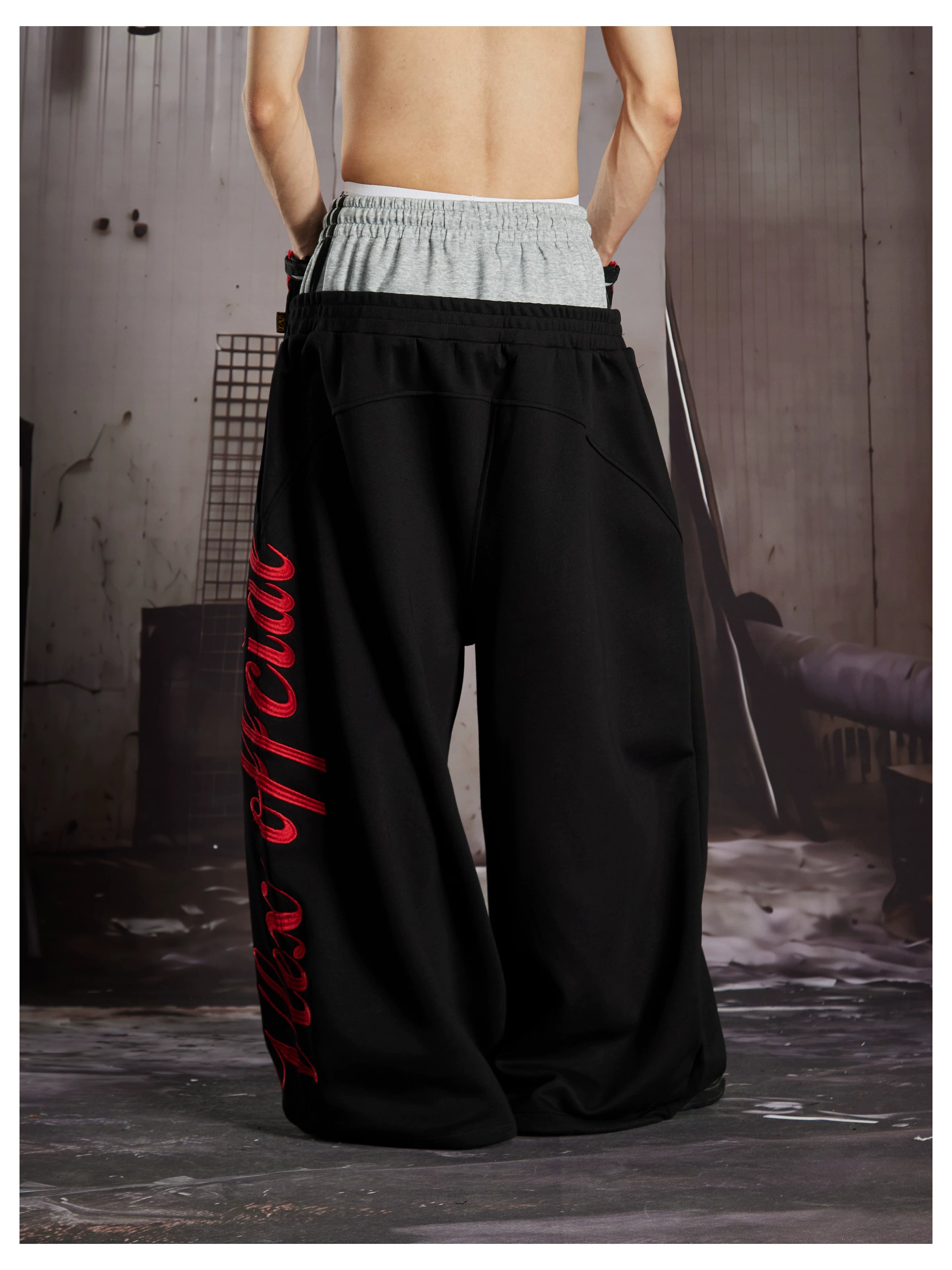 NOMANIAI  Street-style loose-fit casual trousers with double-waistband embroidery.
