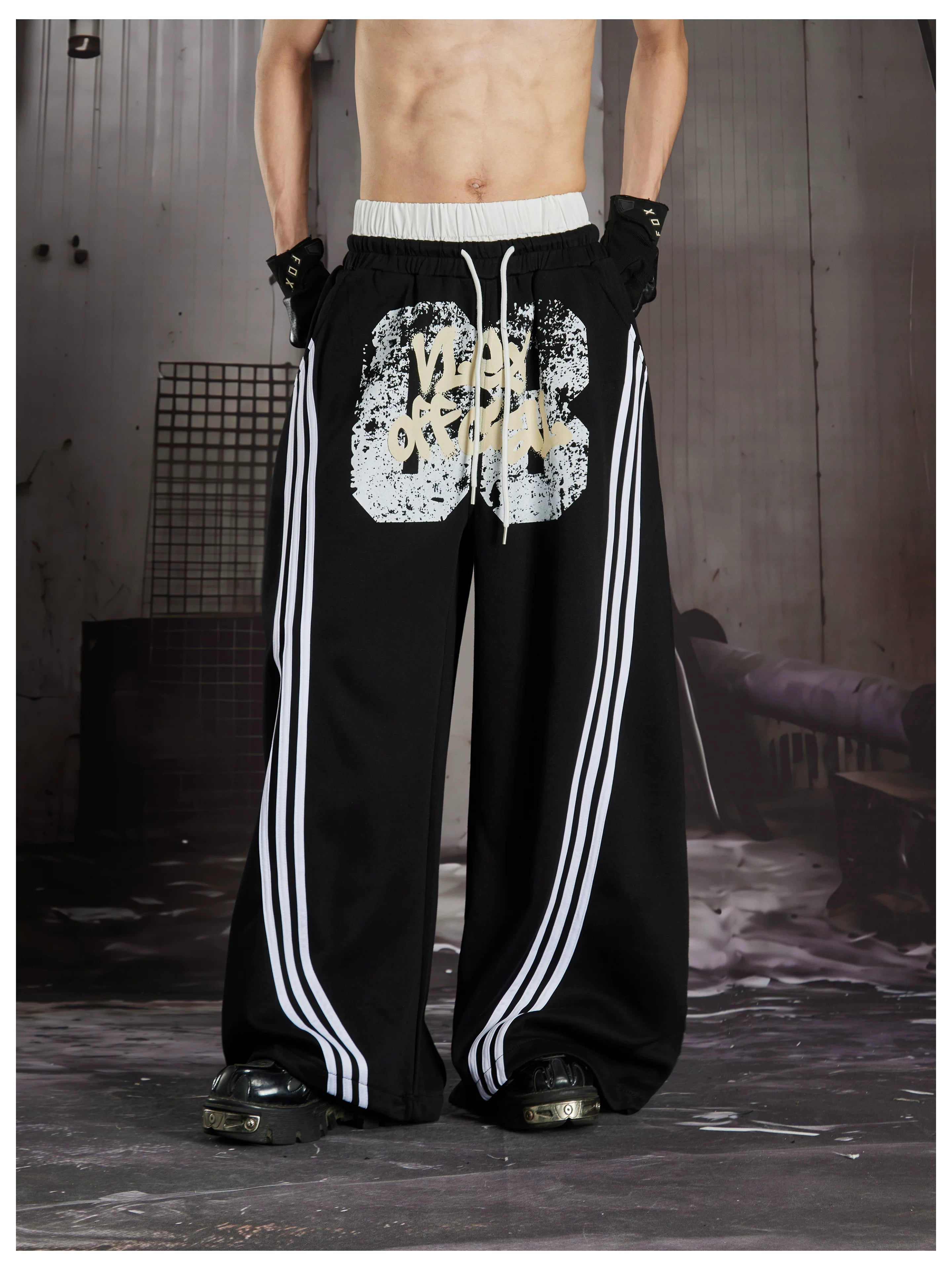 NOMANIAI  Y2K Graffiti-Print Casual Pants with Double-Layer Waistband and Three-Stripe Detail.