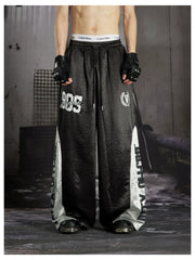 NOMANIAI Street-style casual pants featuring a draped fit, paneling, and a print design.
