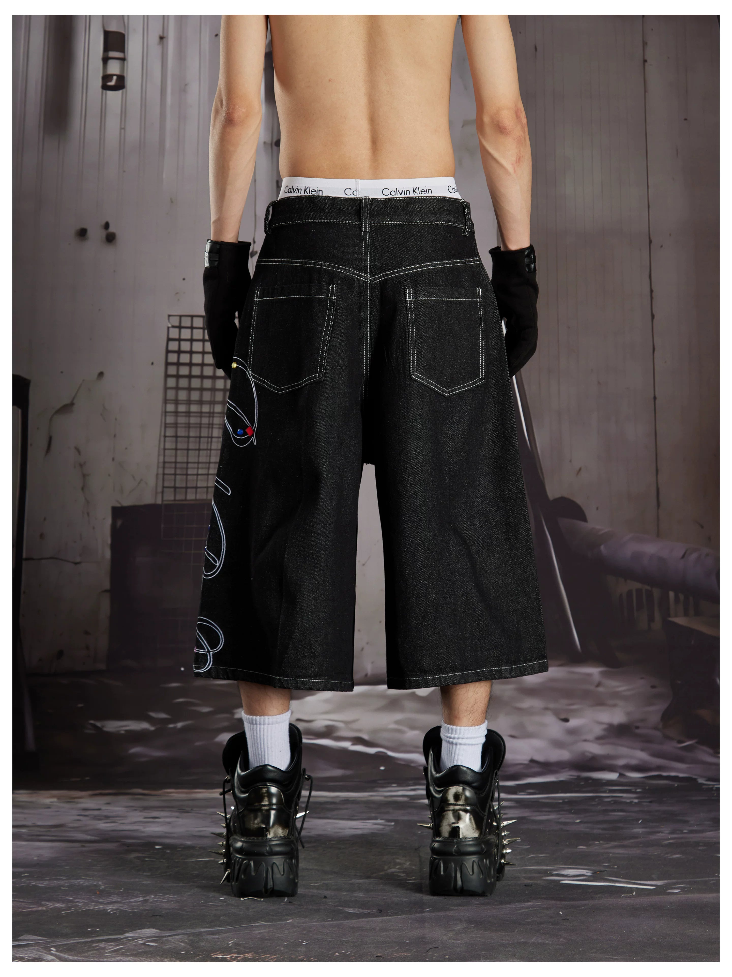 NOMANIAI Cropped jeans with rhinestone and embroidery totem design.