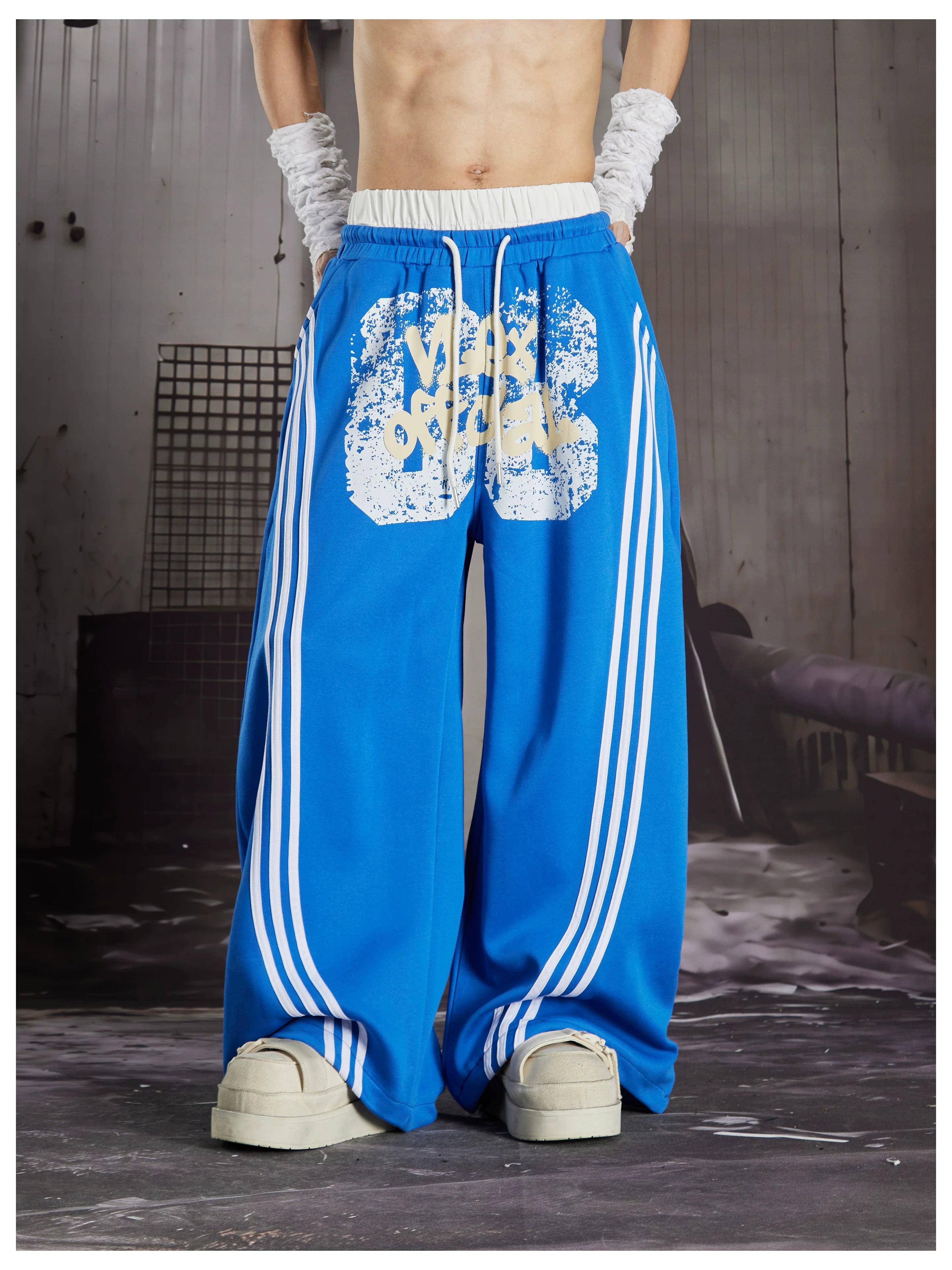 NOMANIAI  Y2K Graffiti-Print Casual Pants with Double-Layer Waistband and Three-Stripe Detail.