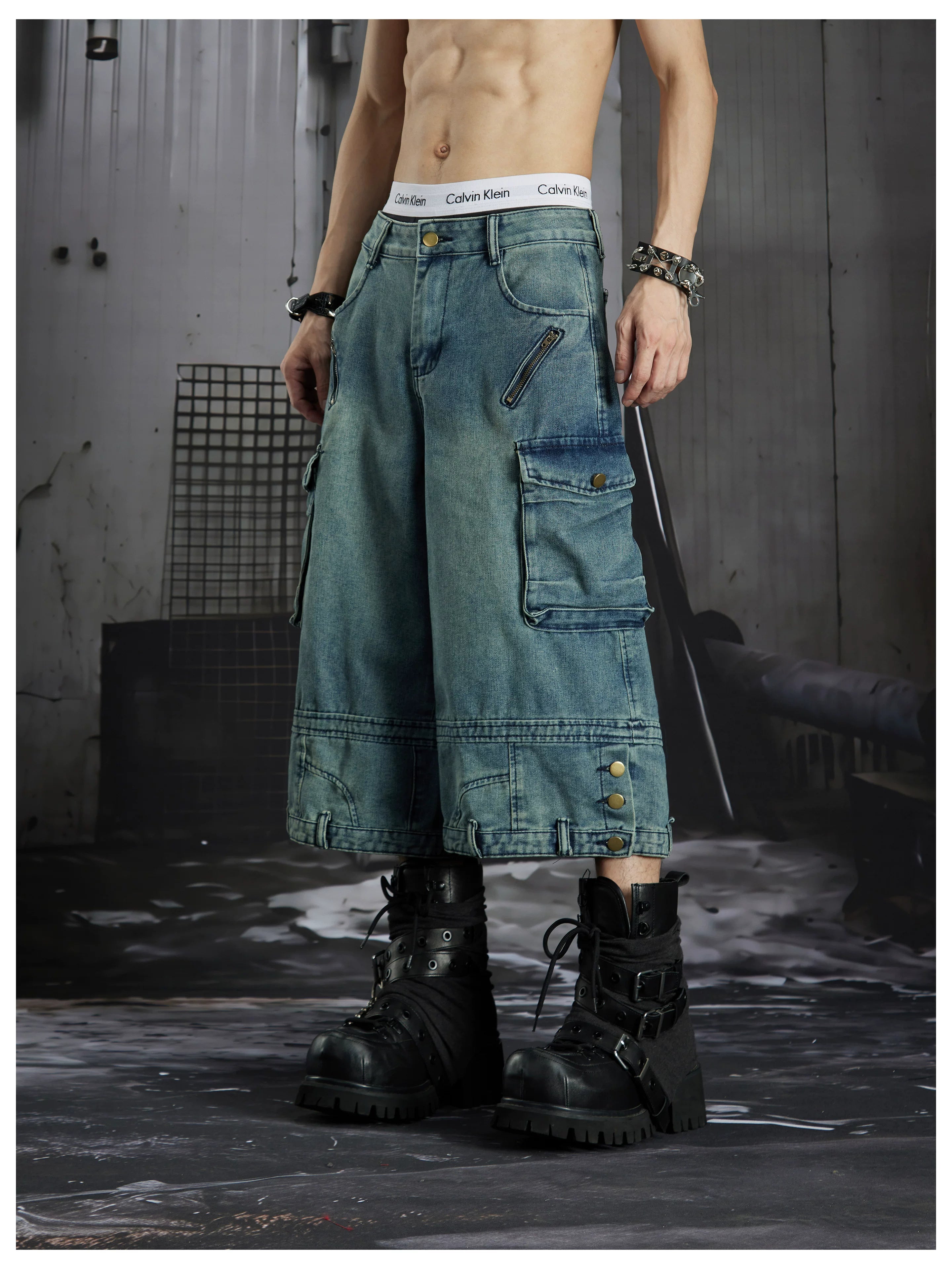 NOMANIAI  Washed, distressed, loose-fit cropped pants with multiple pockets.