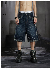 NOMANIAI  Oversized, cropped, studded denim jeans with a punk-style distressed wash.