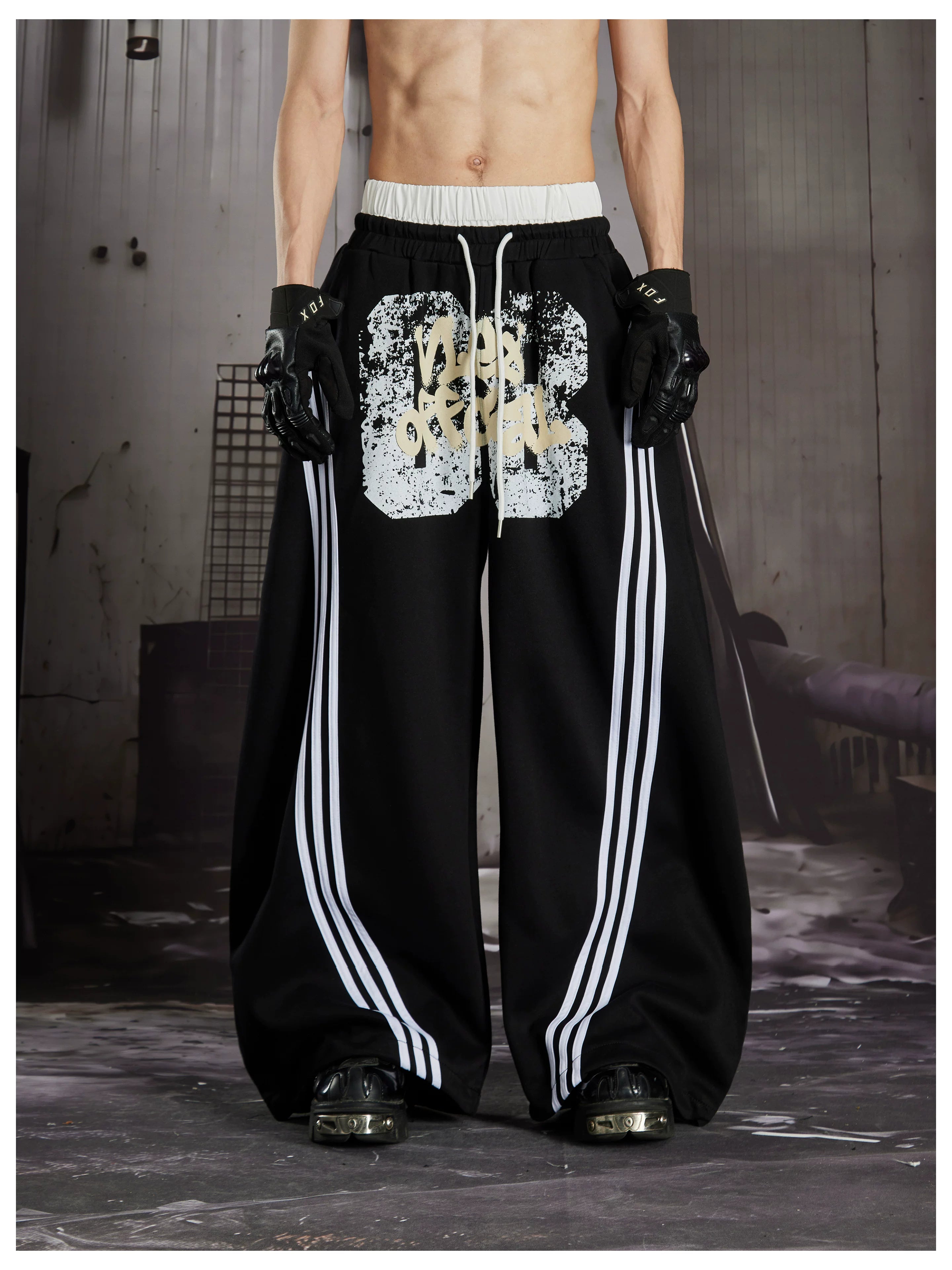 NOMANIAI  Y2K Graffiti-Print Casual Pants with Double-Layer Waistband and Three-Stripe Detail.