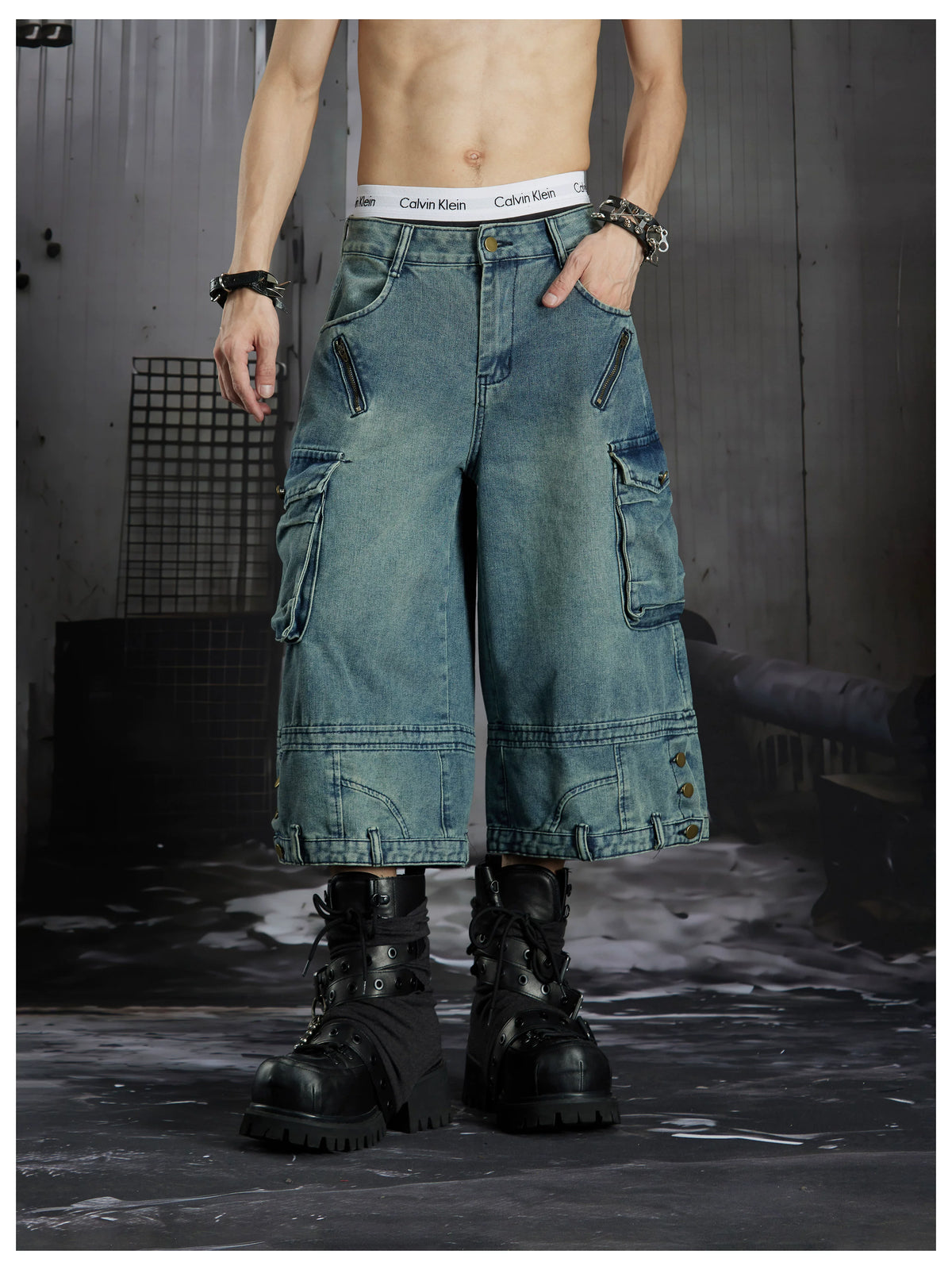 NOMANIAI  Washed, distressed, loose-fit cropped pants with multiple pockets.