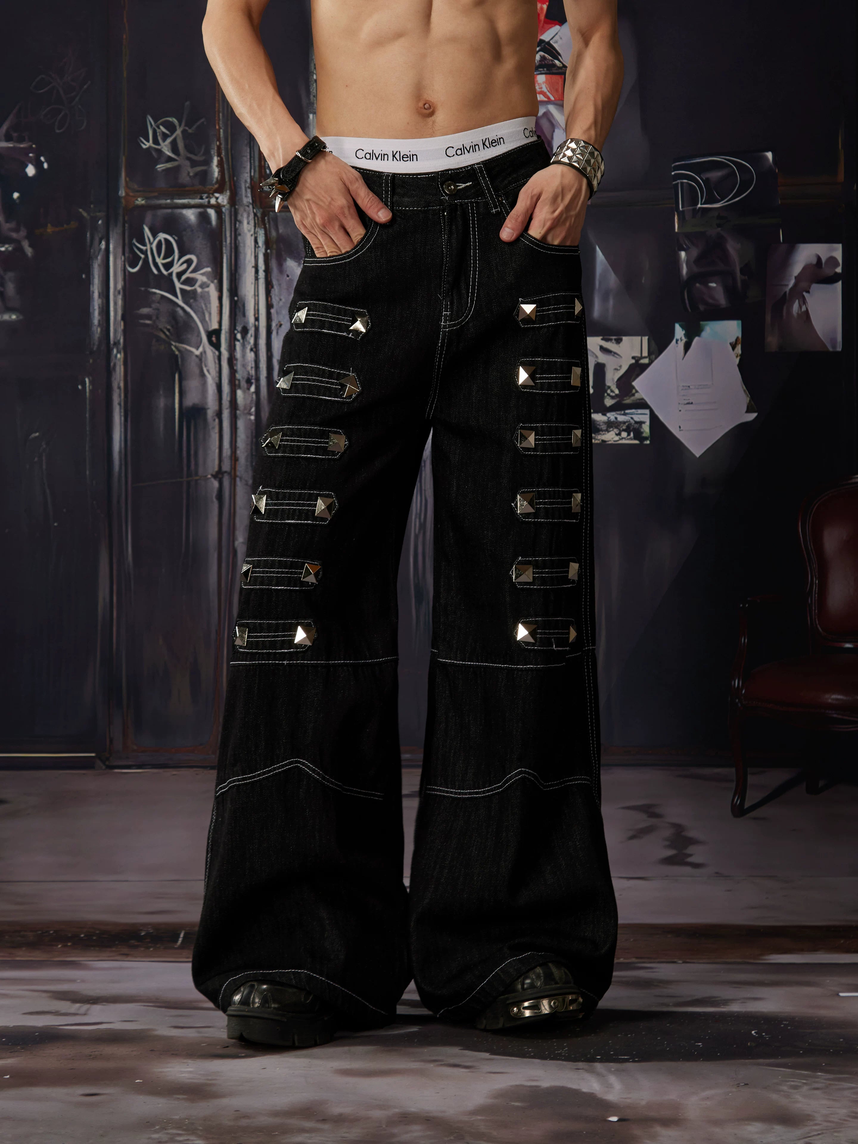 NOMANIAI Y2K-style straight-leg jeans featuring large, dimensional square studs and a distinctive look.