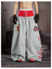 NOMANIAI  Street-style loose-fit casual trousers with double-waistband embroidery.