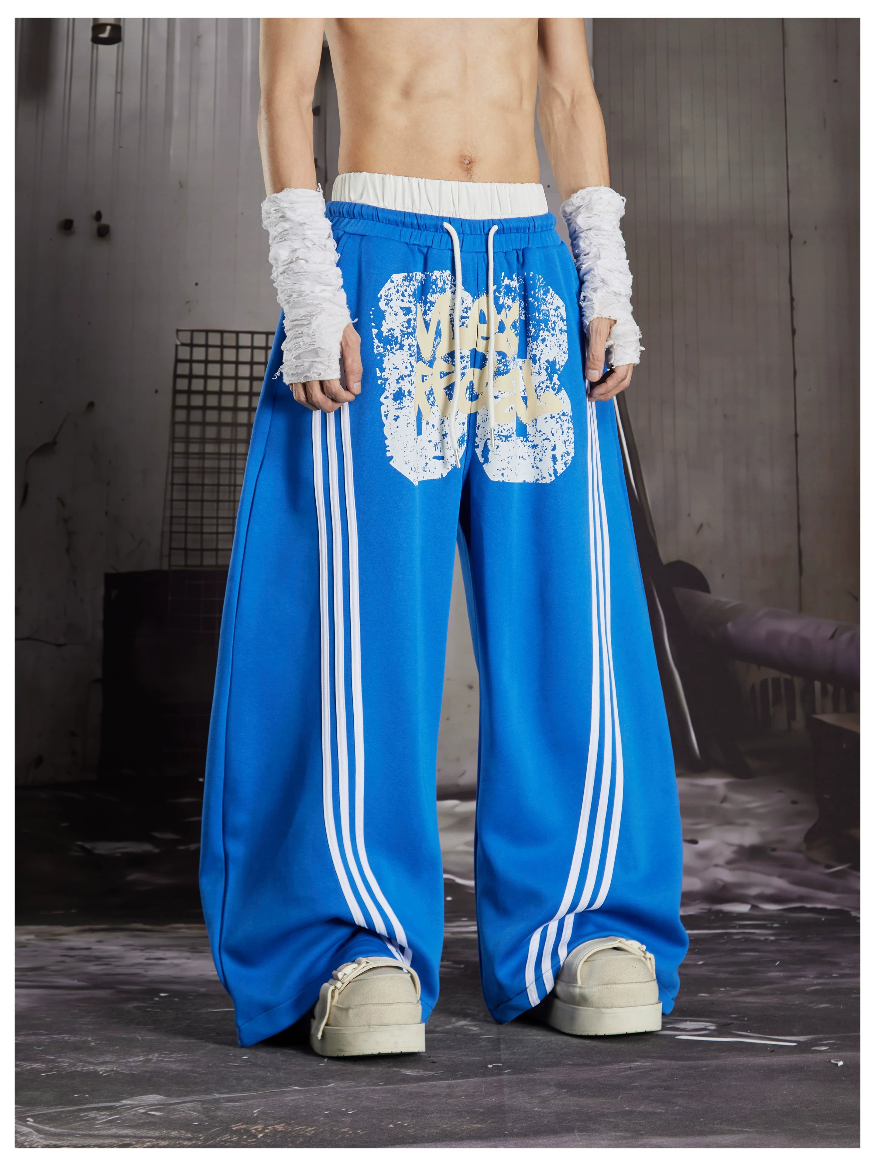 NOMANIAI  Y2K Graffiti-Print Casual Pants with Double-Layer Waistband and Three-Stripe Detail.