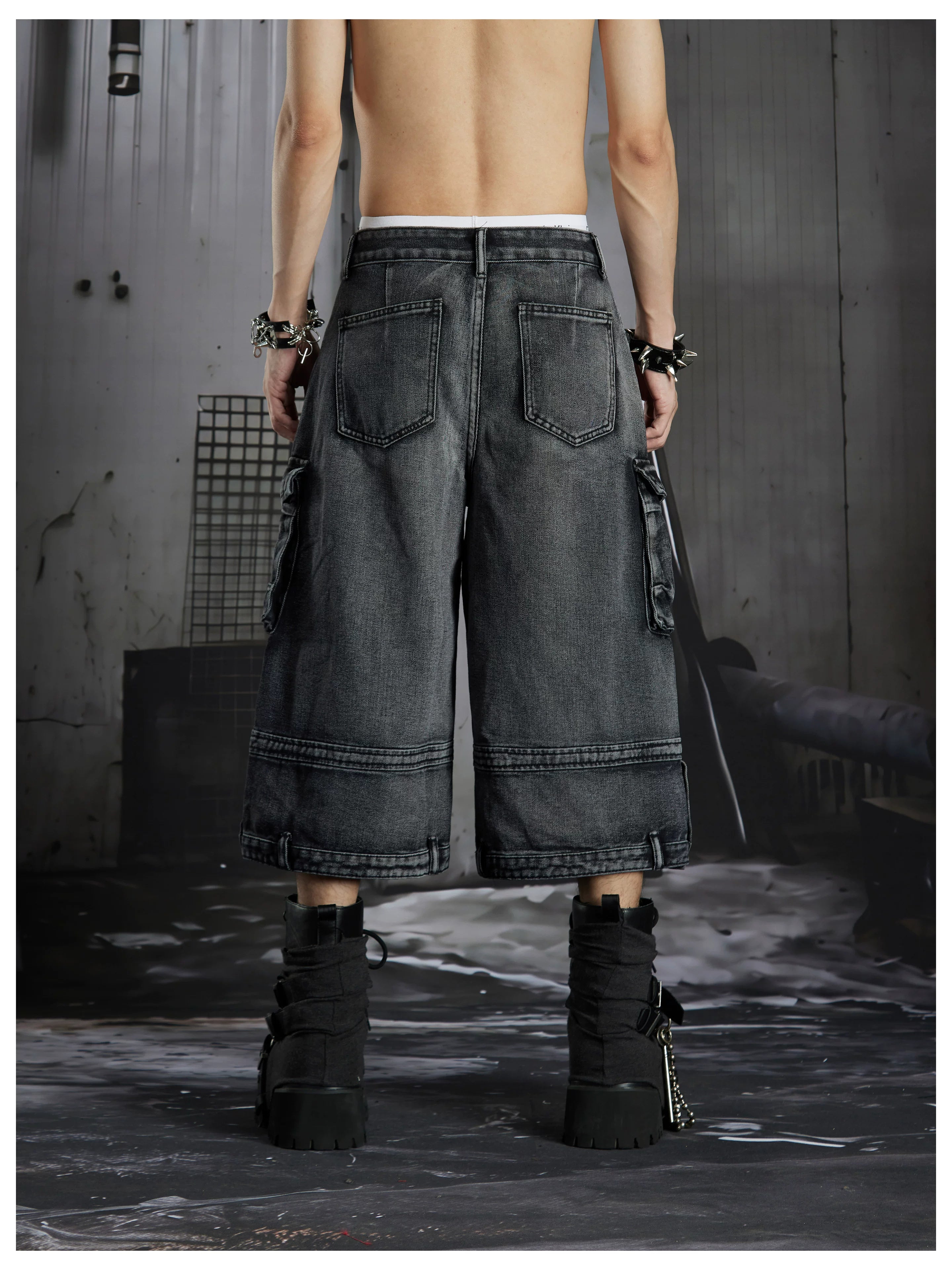 NOMANIAI  Washed, distressed, loose-fit cropped pants with multiple pockets.