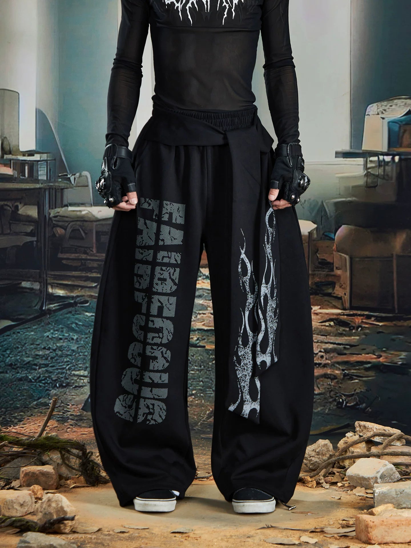 NOMANIAI Loose-fitting trousers with a totem print and Y2K-style lace-up detailing.