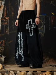 NOMANIAI Elastic-waist casual curved-leg trousers with cross-motif print.