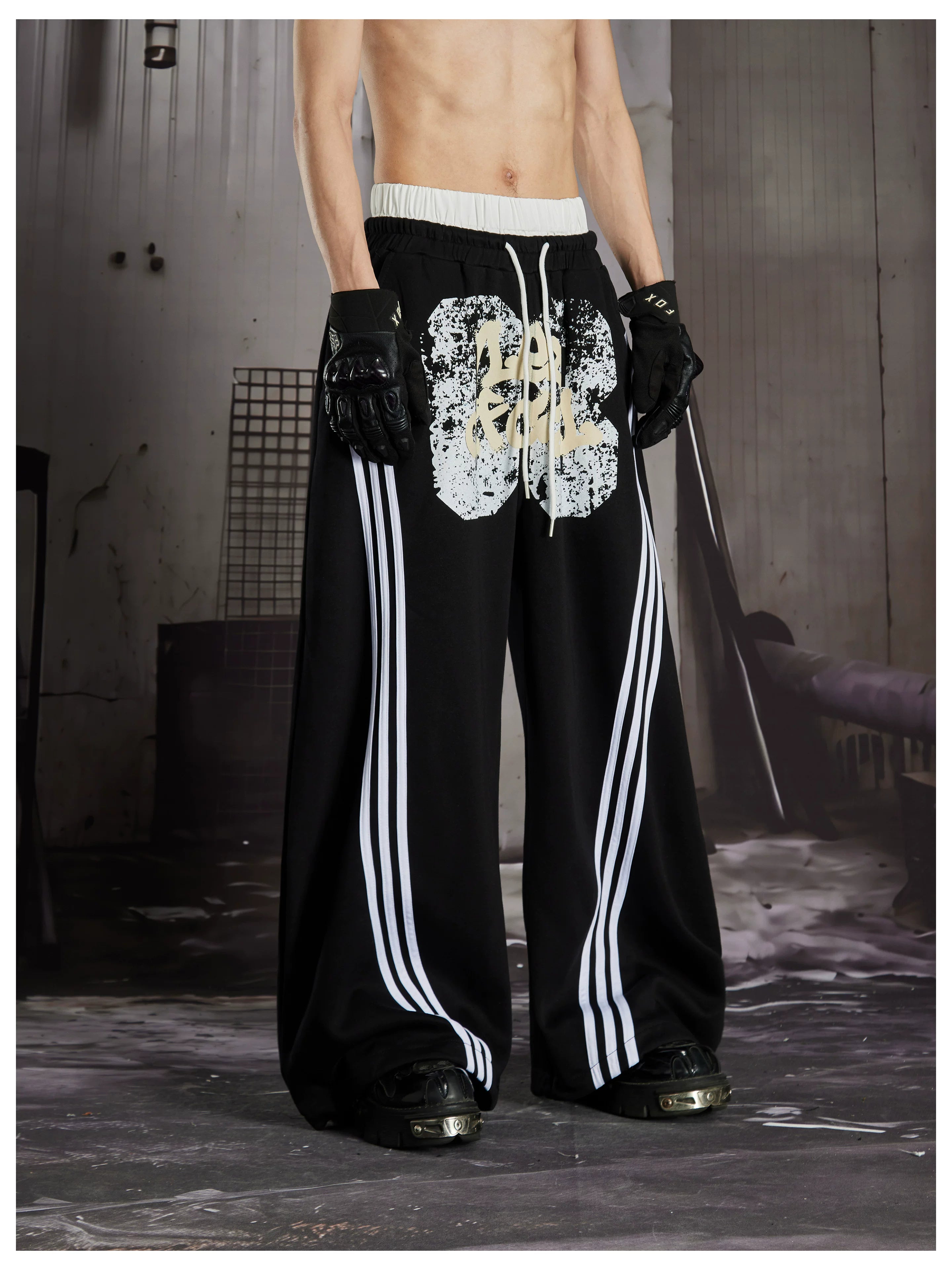 NOMANIAI  Y2K Graffiti-Print Casual Pants with Double-Layer Waistband and Three-Stripe Detail.