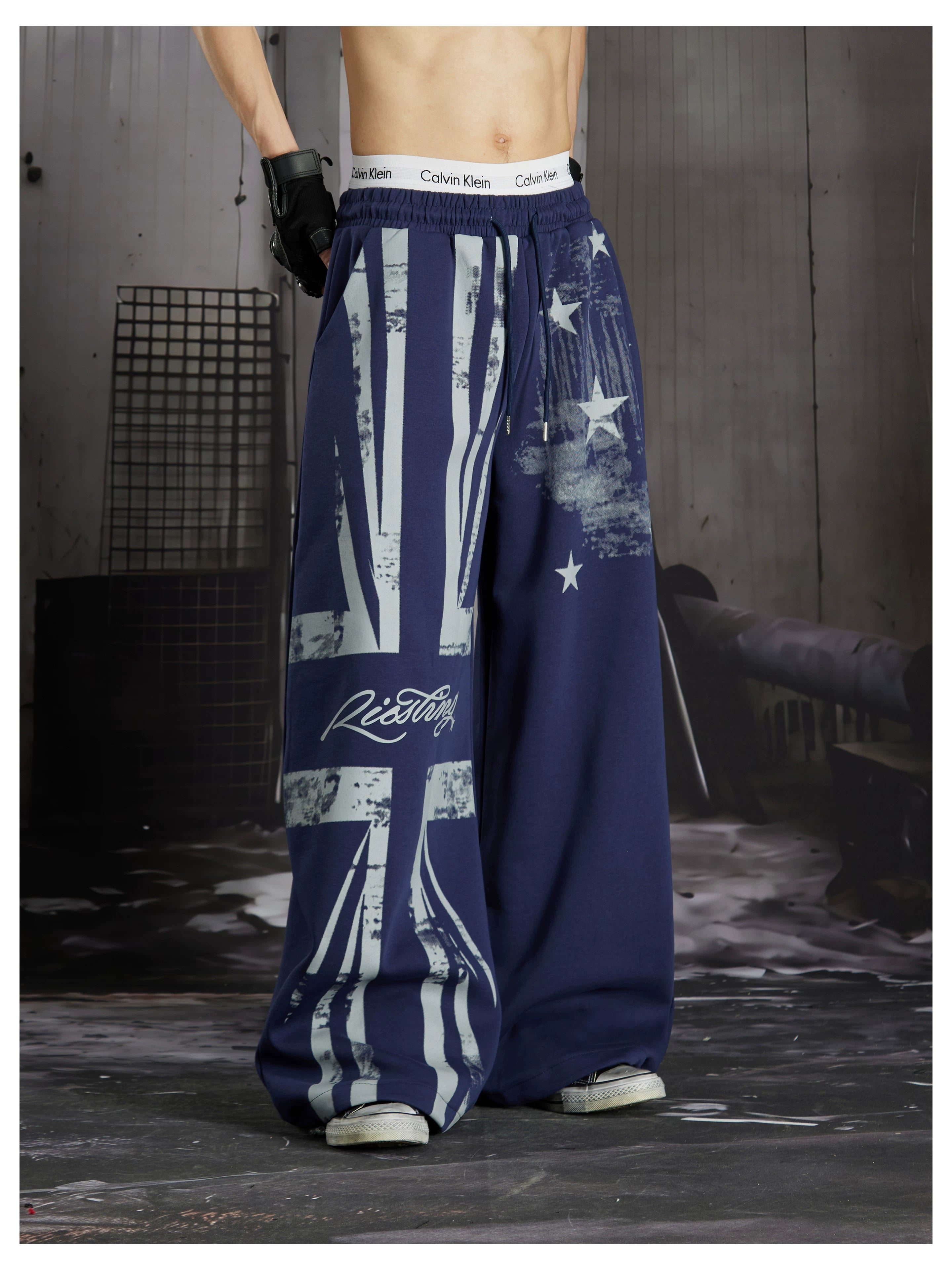 NOMANIAI  Distressed Union Jack star-print loose-fit casual sweatpants with an elastic waist.