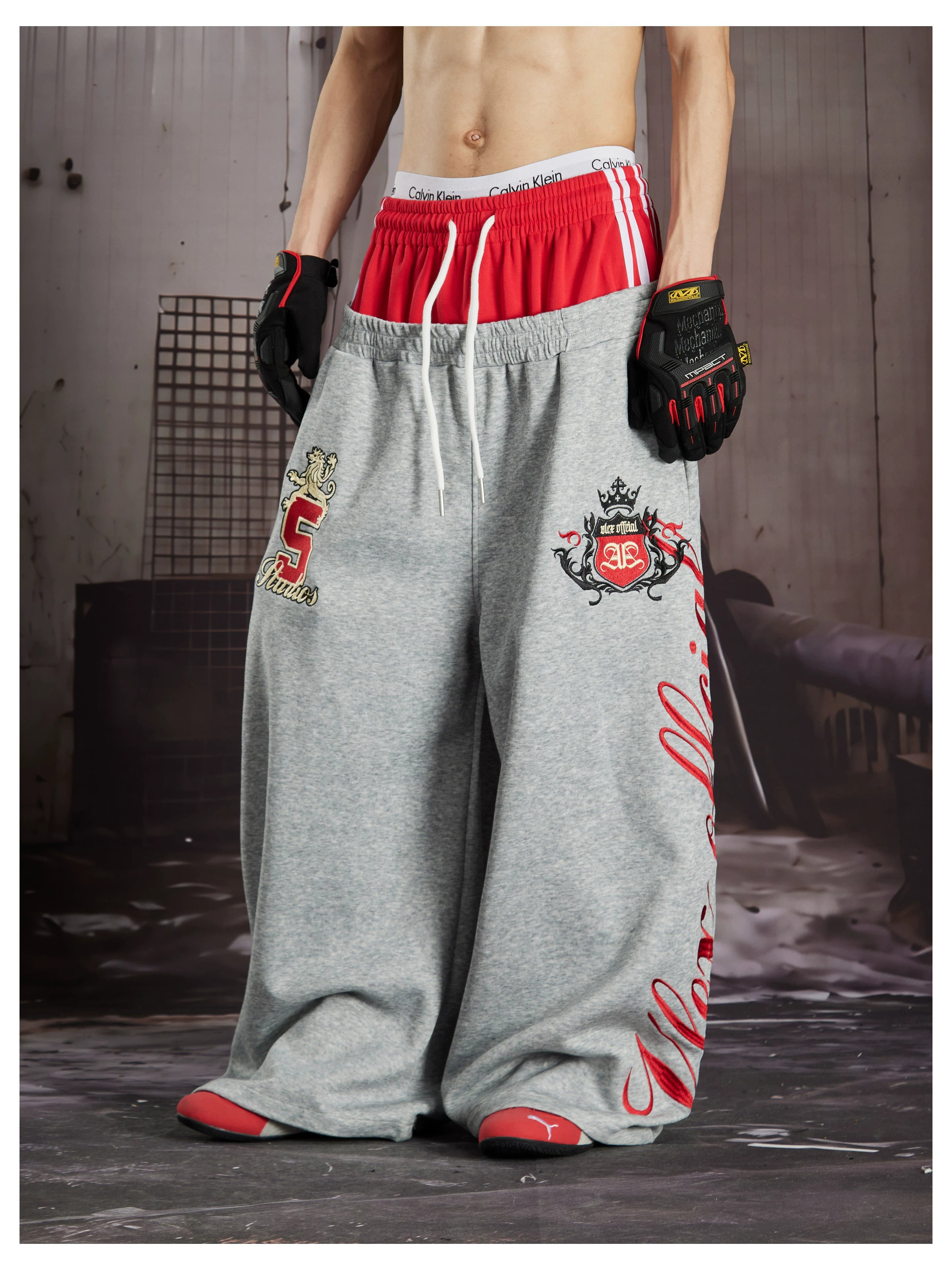 NOMANIAI  Street-style loose-fit casual trousers with double-waistband embroidery.