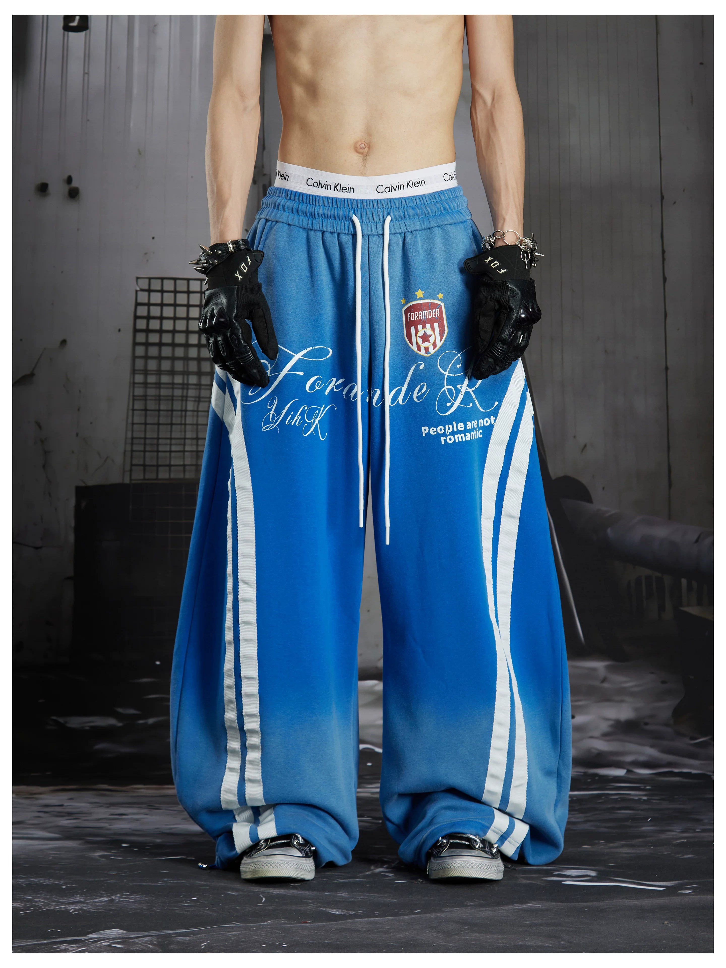 NOMANIAI Street-style distressed print loose-fit sweatpants.