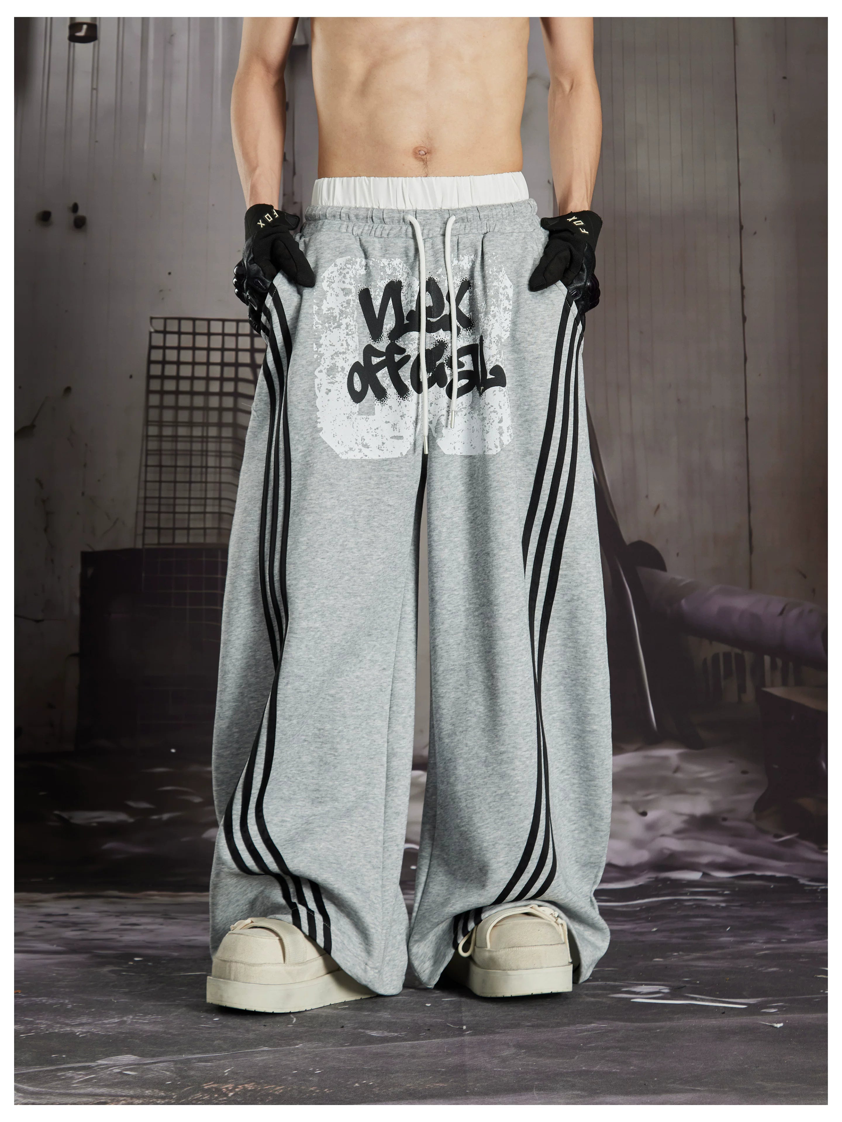 NOMANIAI  Y2K Graffiti-Print Casual Pants with Double-Layer Waistband and Three-Stripe Detail.