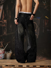 NOMANIAI  Loose-fit, acid-washed, distressed denim jeans featuring rhinestone-studded streamers.