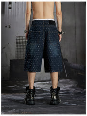 NOMANIAI  Oversized, cropped, studded denim jeans with a punk-style distressed wash.