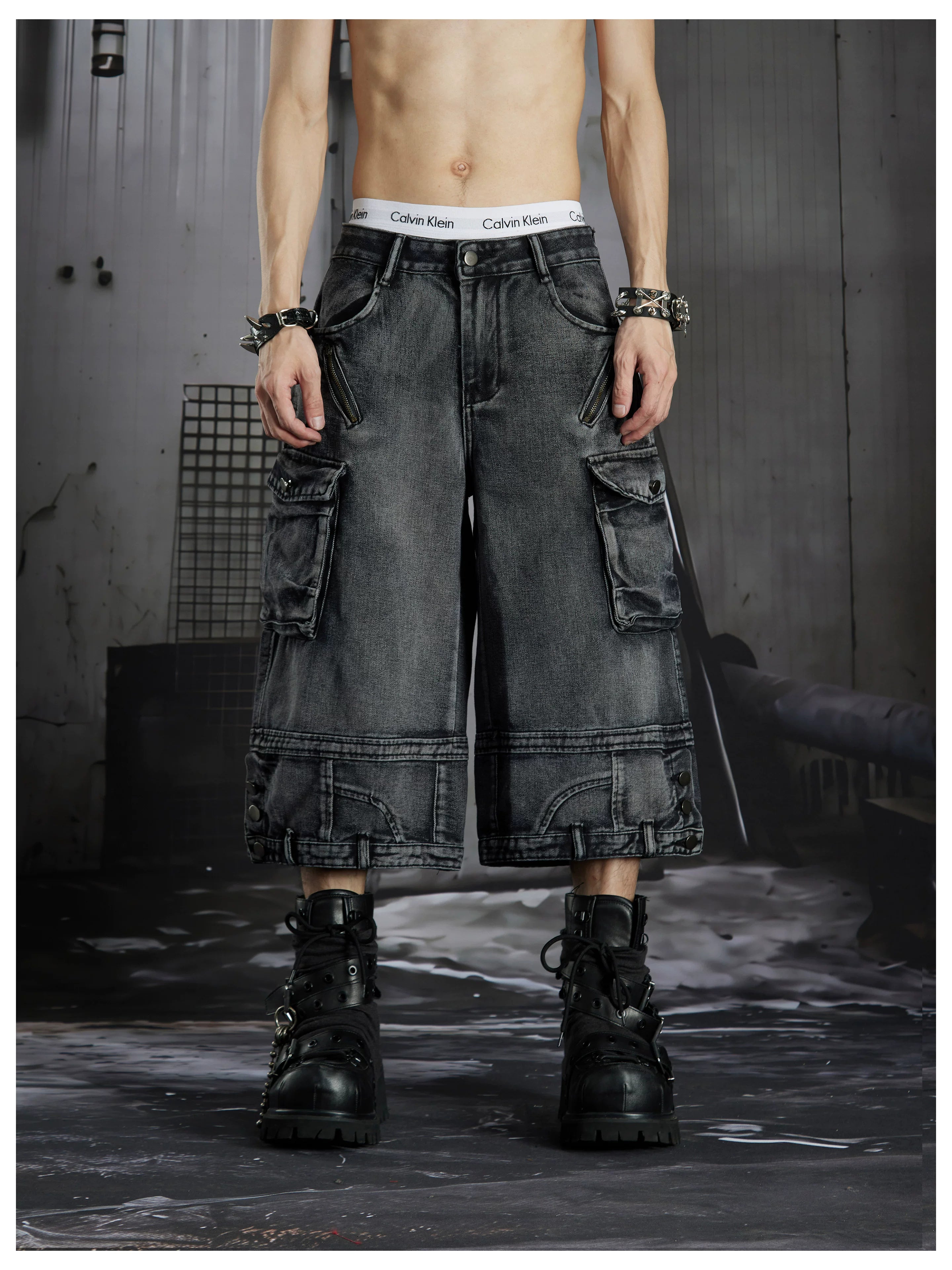 NOMANIAI  Washed, distressed, loose-fit cropped pants with multiple pockets.